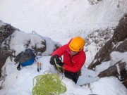 Gearing up at the first belay, notice the sun glasses? Guess who loaned his goggles to someone?